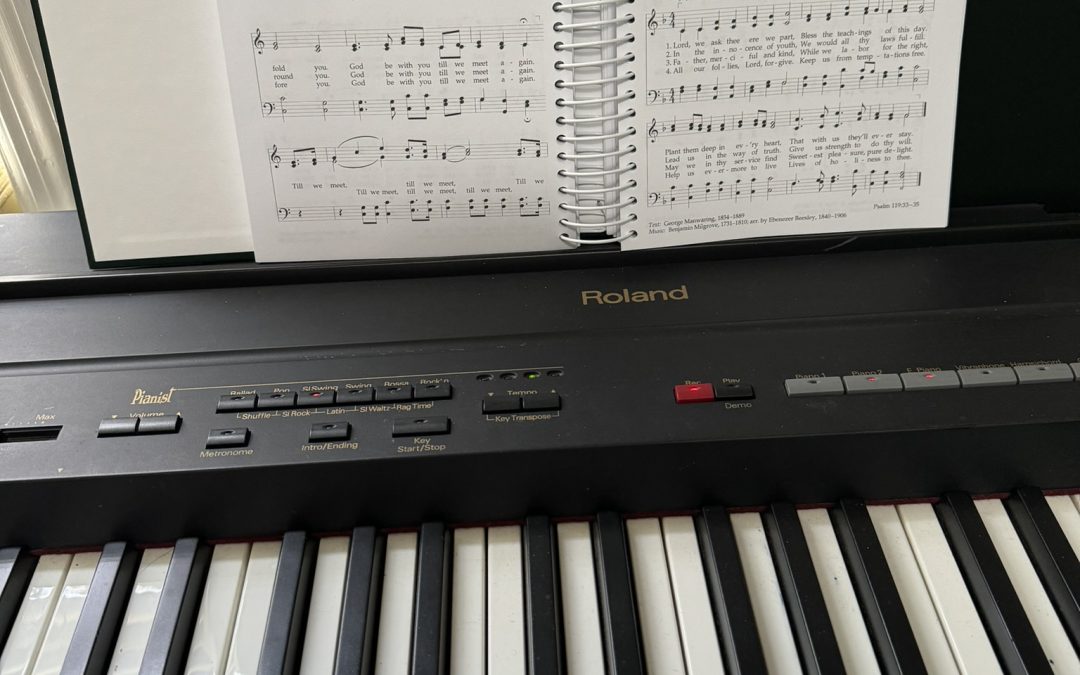 Image of electric piano with open hymnbook in place.